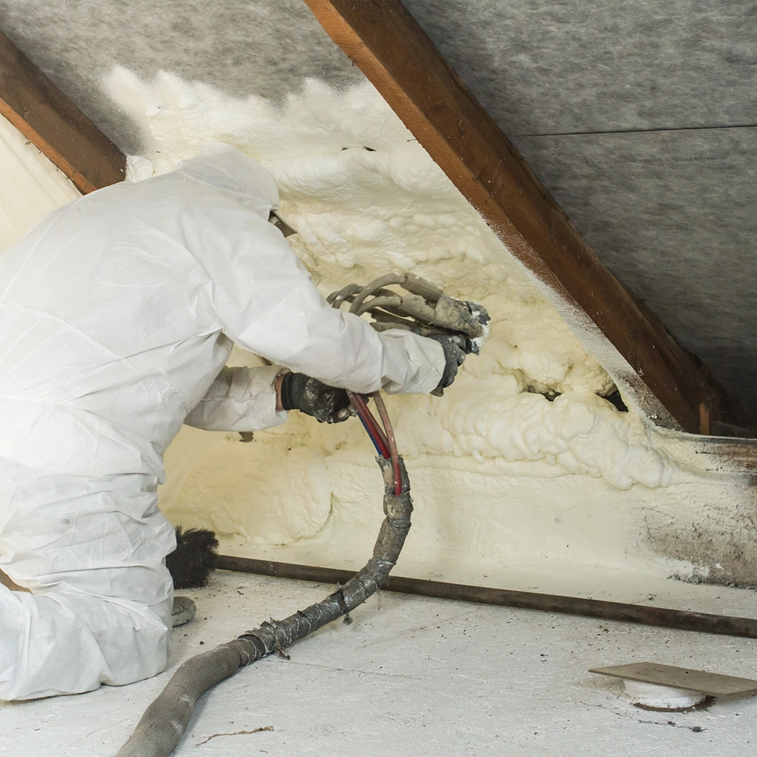 Tech Spraying Foam in Attic